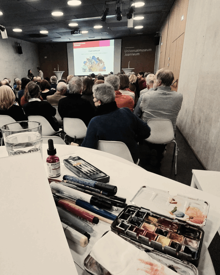 Fotografie von Laura Schindler beim Eventzeichnen während einer Veranstaltung im Universalmuseum Joanneum.